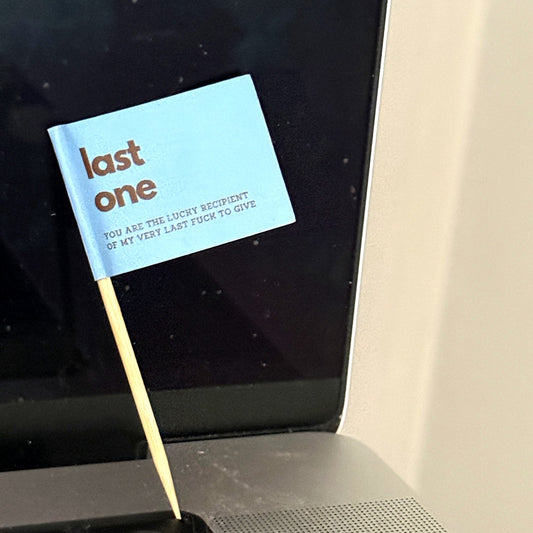 Last One toothpick flag stuck in a laptop keyboard
