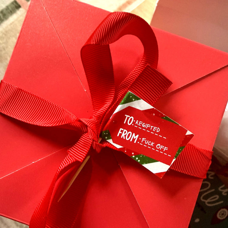 Regifted Fuck Off flag used as a gift tag on a red box
