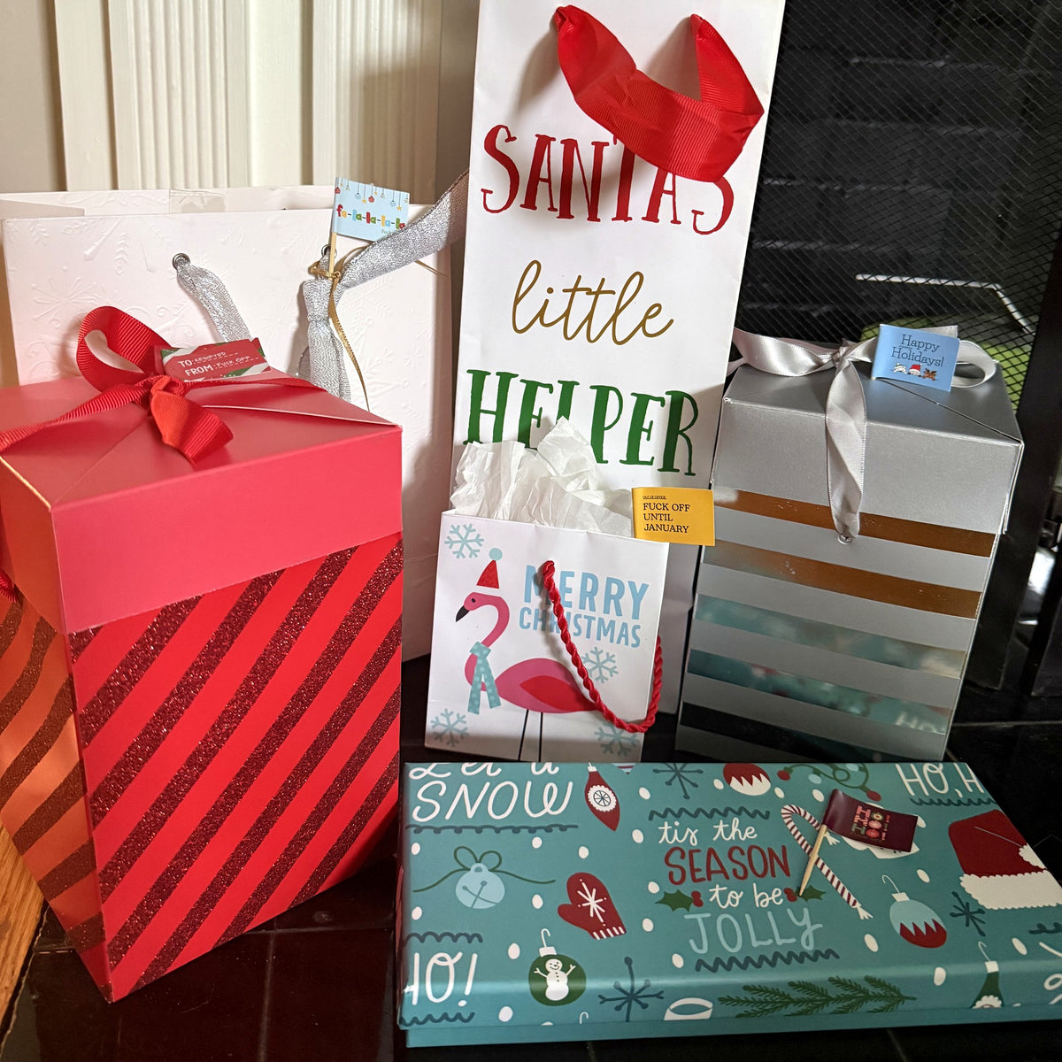 Holiday toothpick flags on a pile of wrapped gifts