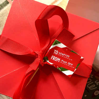 Regifted Fuck Off flag used as a gift tag on a red box