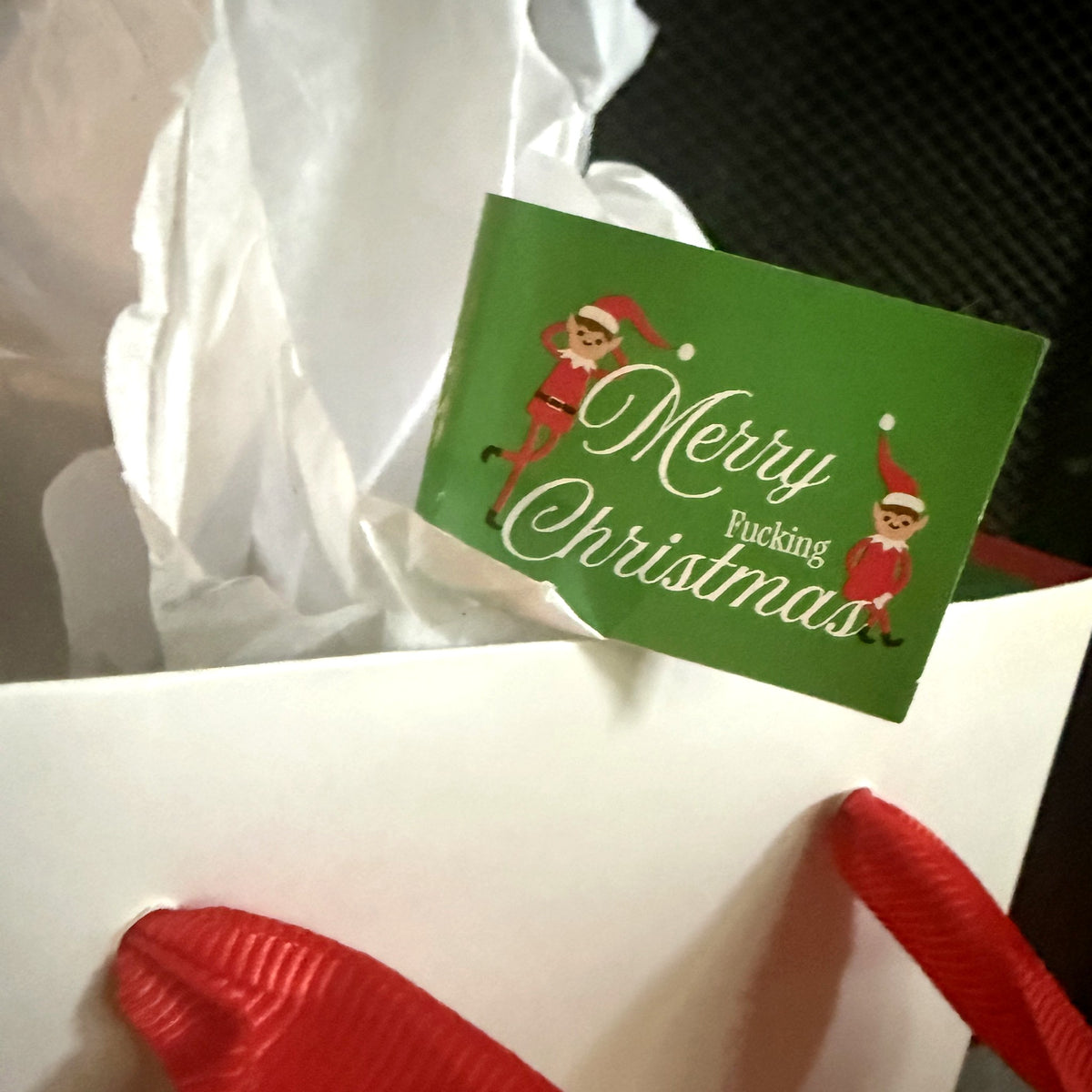 Merry Fucking Christmas flag in a gift bag